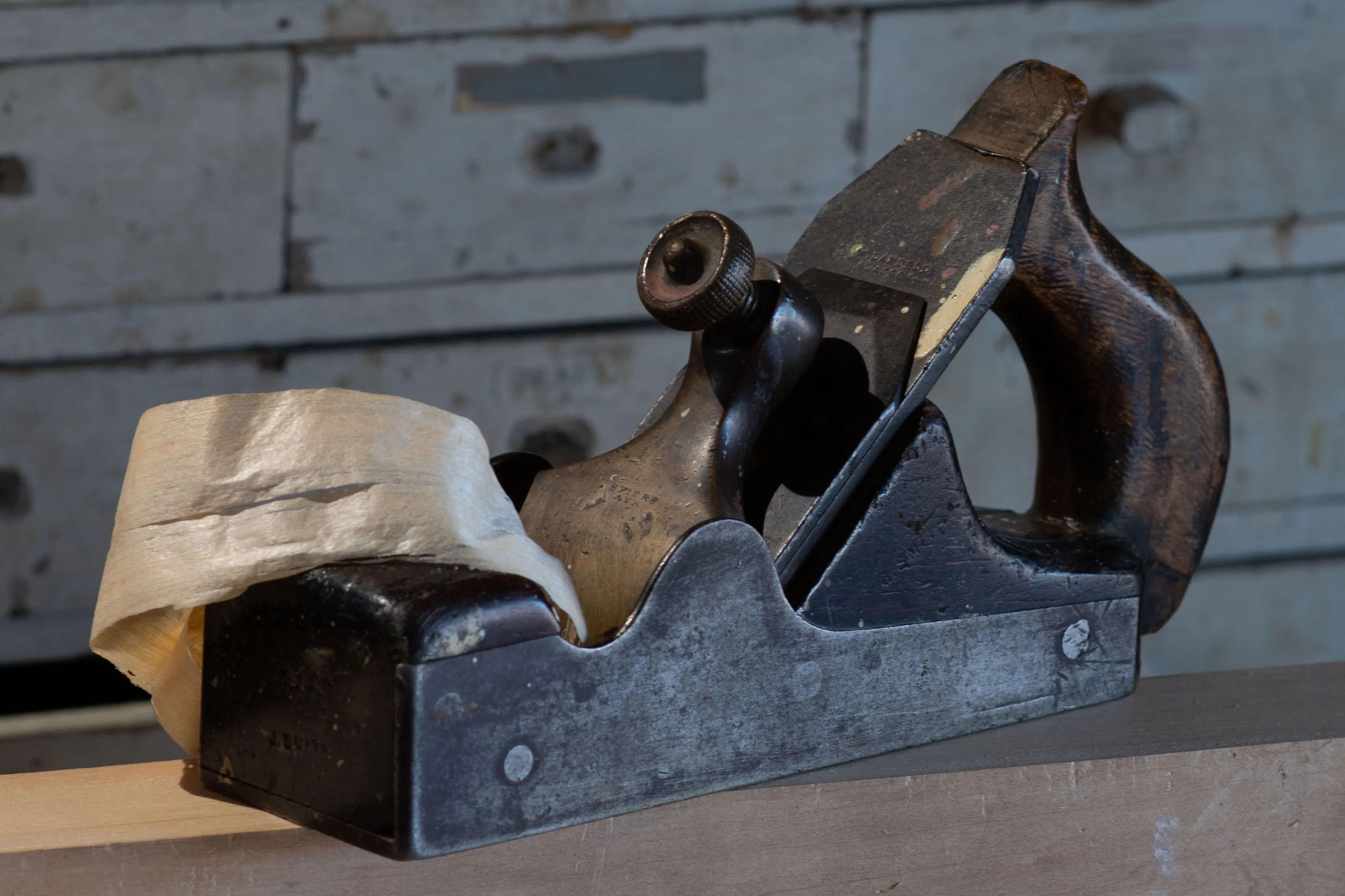 Collection of vintage Stanley Bailey bench planes numbered 3 through 7 arranged on a wooden workbench