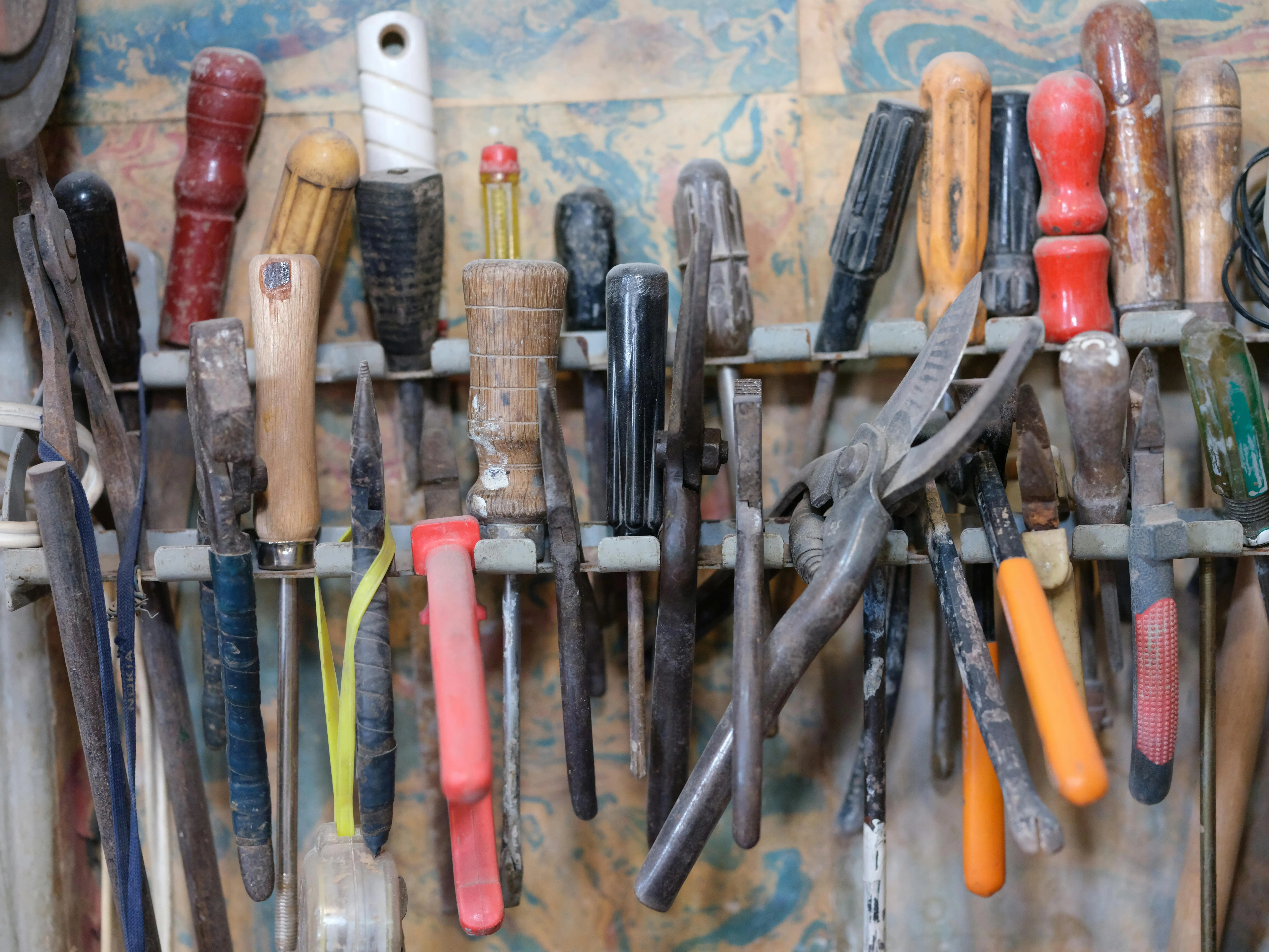 Complete collection of hand tools laid out on a wooden workbench
